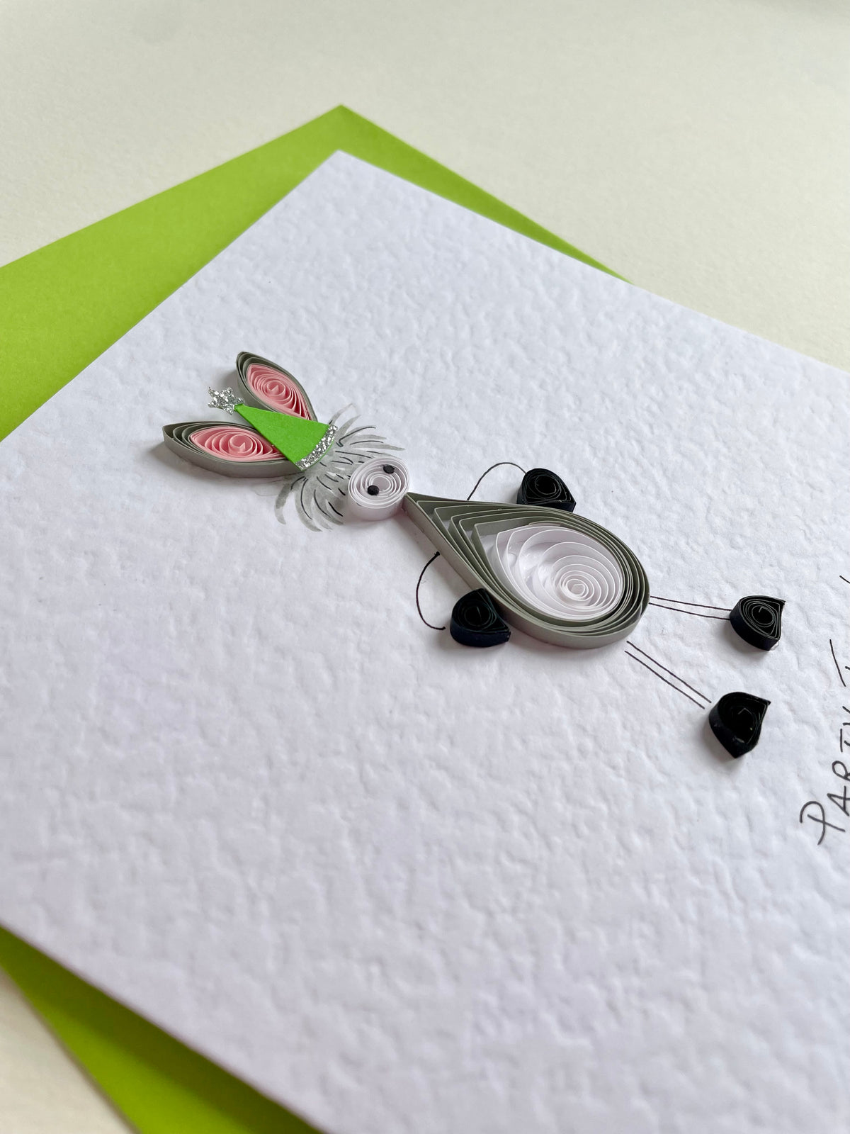 Showing 3D quilling of donkey and decoupage party hat with glitter trim on hammered cardstock. 