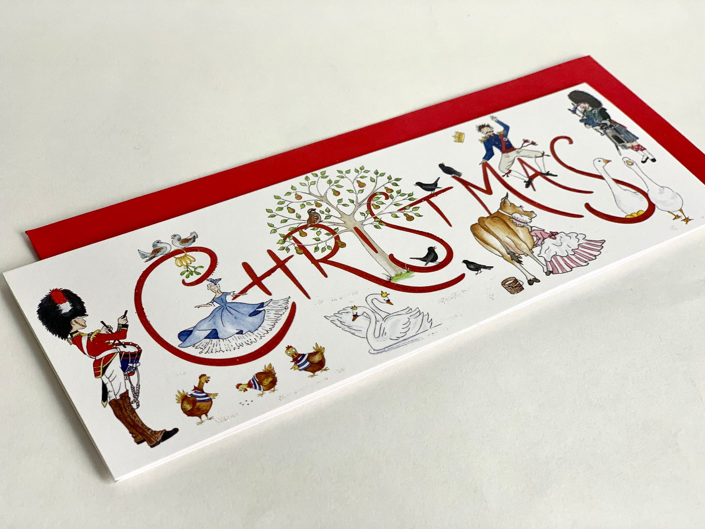 Non-glitter version showing cloes-up of original watercolour and fine quality matt uncoated cardstock with Christmas red envelope behind.
