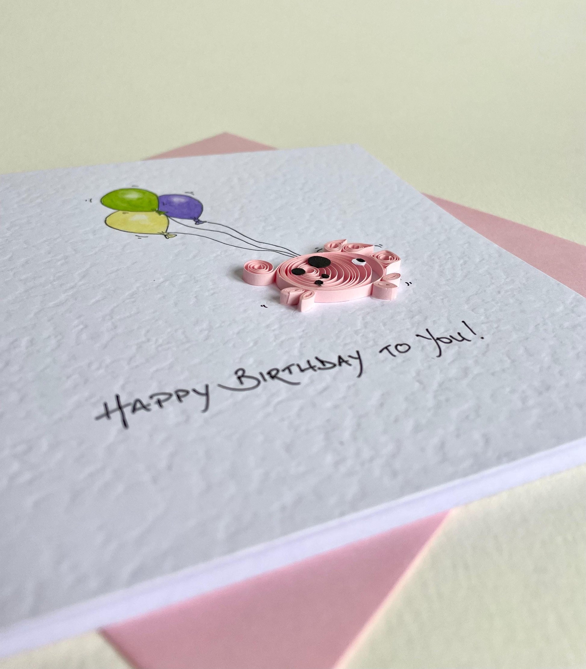 side view showing raised 3D quilled pig design on card