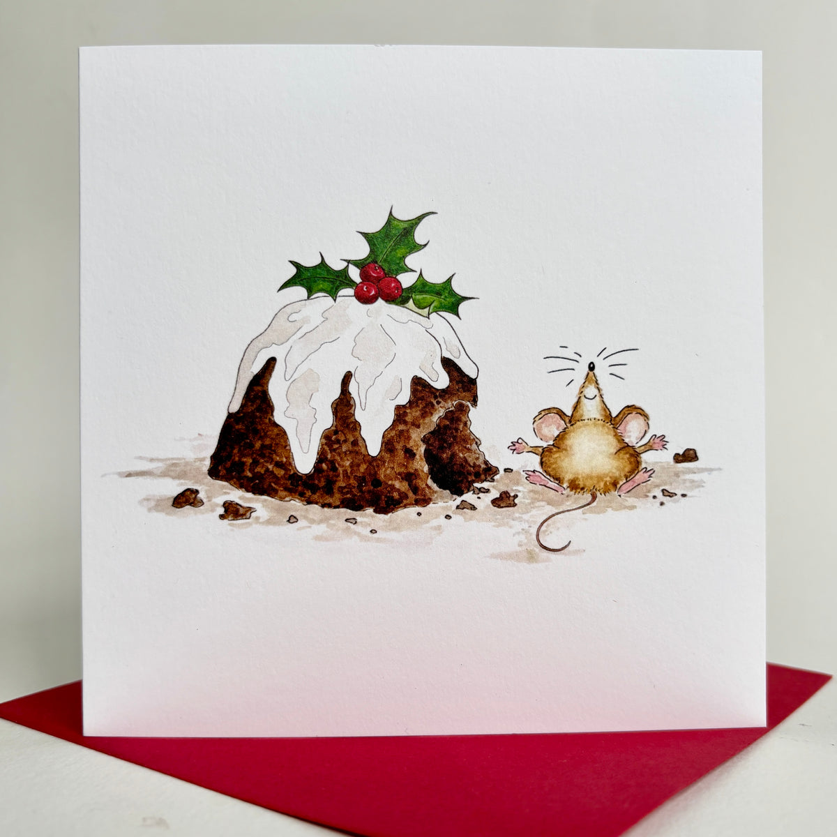 Available in packs or individual cards - square Christmas card, produced from my own hand-painted watercolour illustration of a pudding with holly and a small mouse, displayed on matching crimson red envelope.