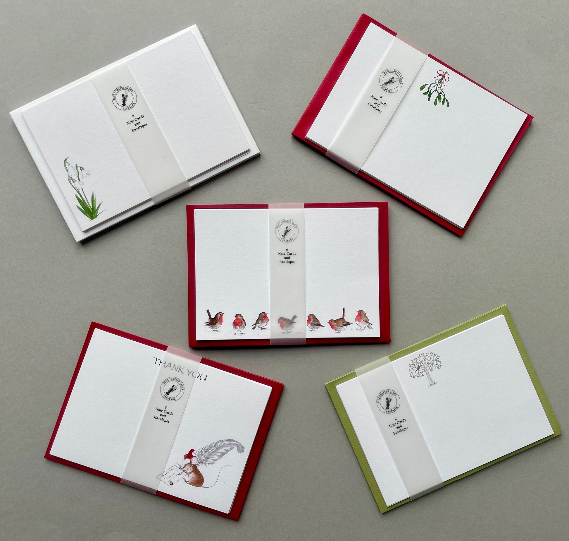 Original watercolour Christmas notecard sets with coordinating coloured envelopes from Blue Lobster Cards.