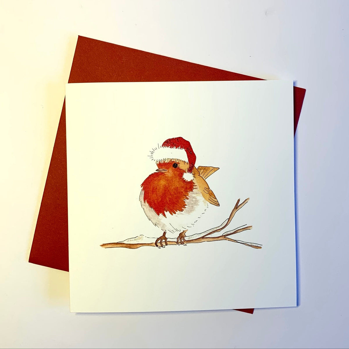 Original watercolour of a traditional robin christmas card printed onto fine quality 300gsm cardstock. Option of glitter. Supplied with red envelope