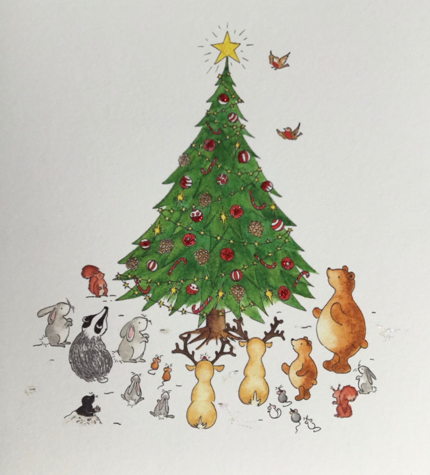Showing detail of animals and hand-painted tree with decorations - badger. bear, reindeer, rabbits / bunny, mice, mole and squirrels in a snowy woodland scene