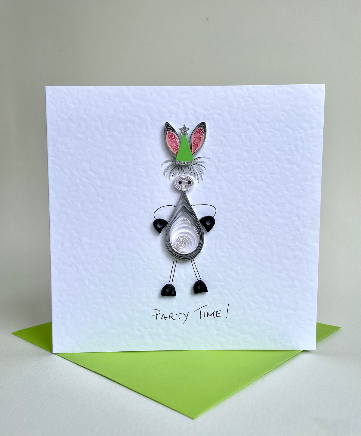 Standing image of handmade quilled donkey with party hat. Designed myself. Hand painted and trimmed with glitter on 300gsm white hammered card. Supplied with green envelope. Cards can be personalised. 