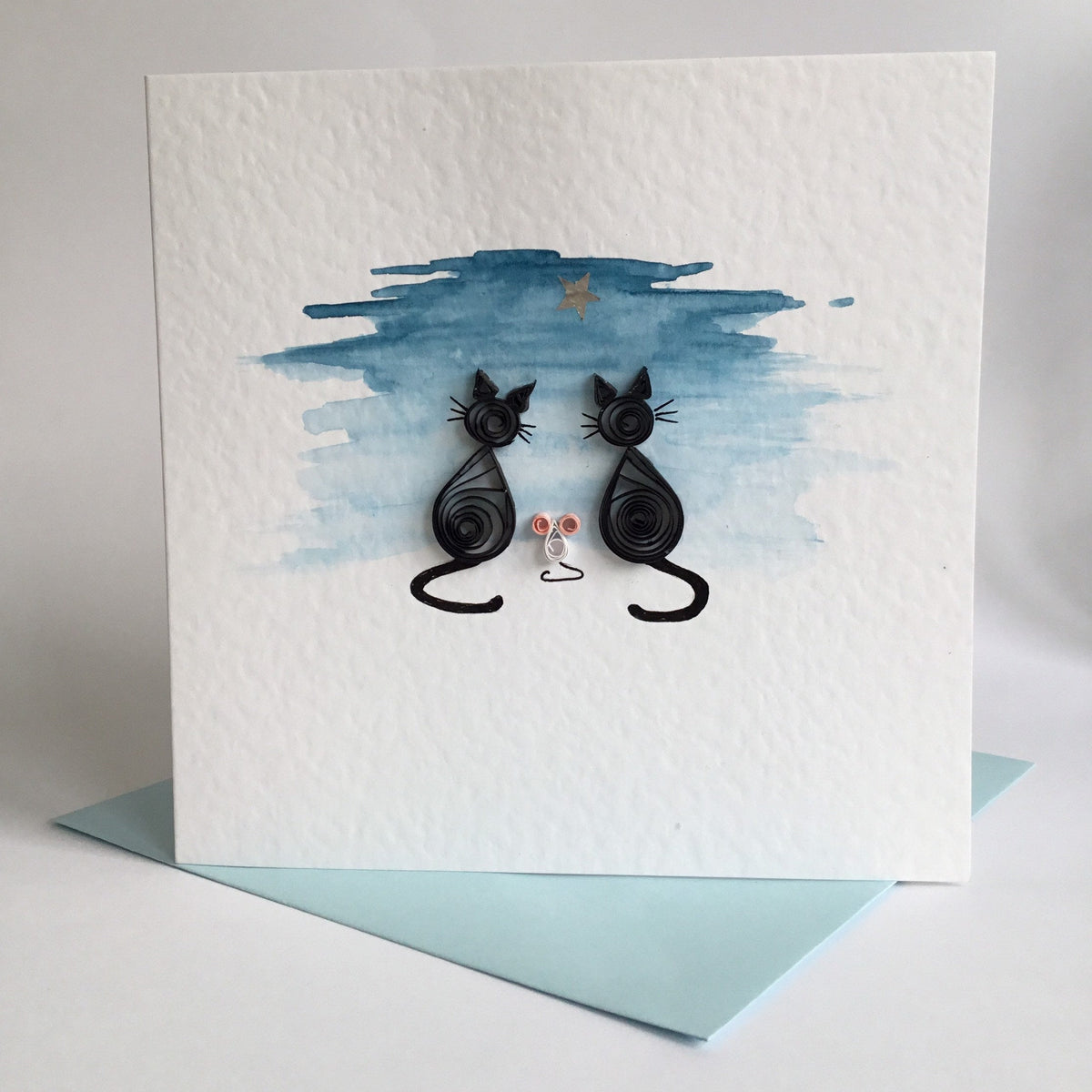 Hand painted twilight sky featuring two quillled black cats with a little white mouse looking at a glitter star. Displayed in 300gsm hammered card and set on blue envelope. 