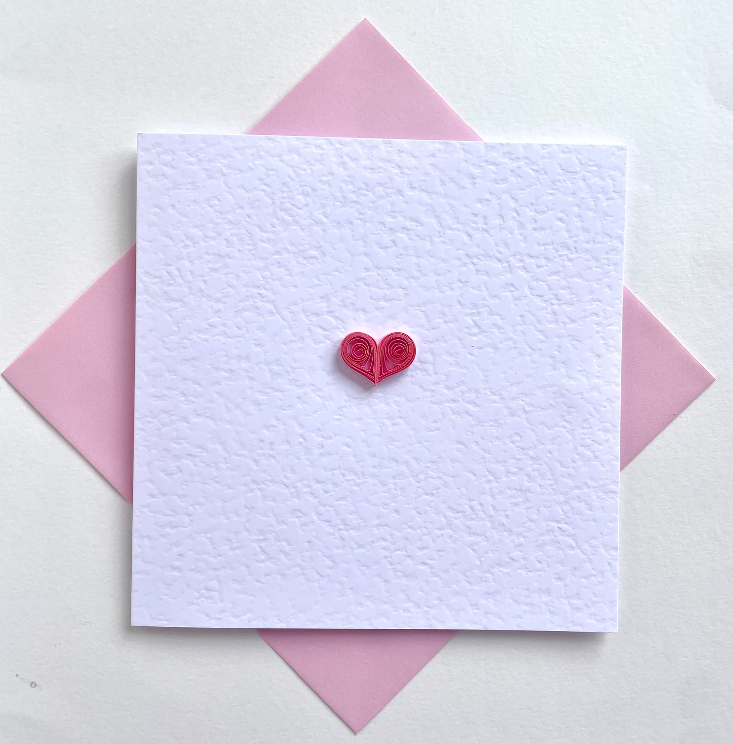 Pretty pink heart on white hammer card with pink envelope. Love & friendship greetings card for her