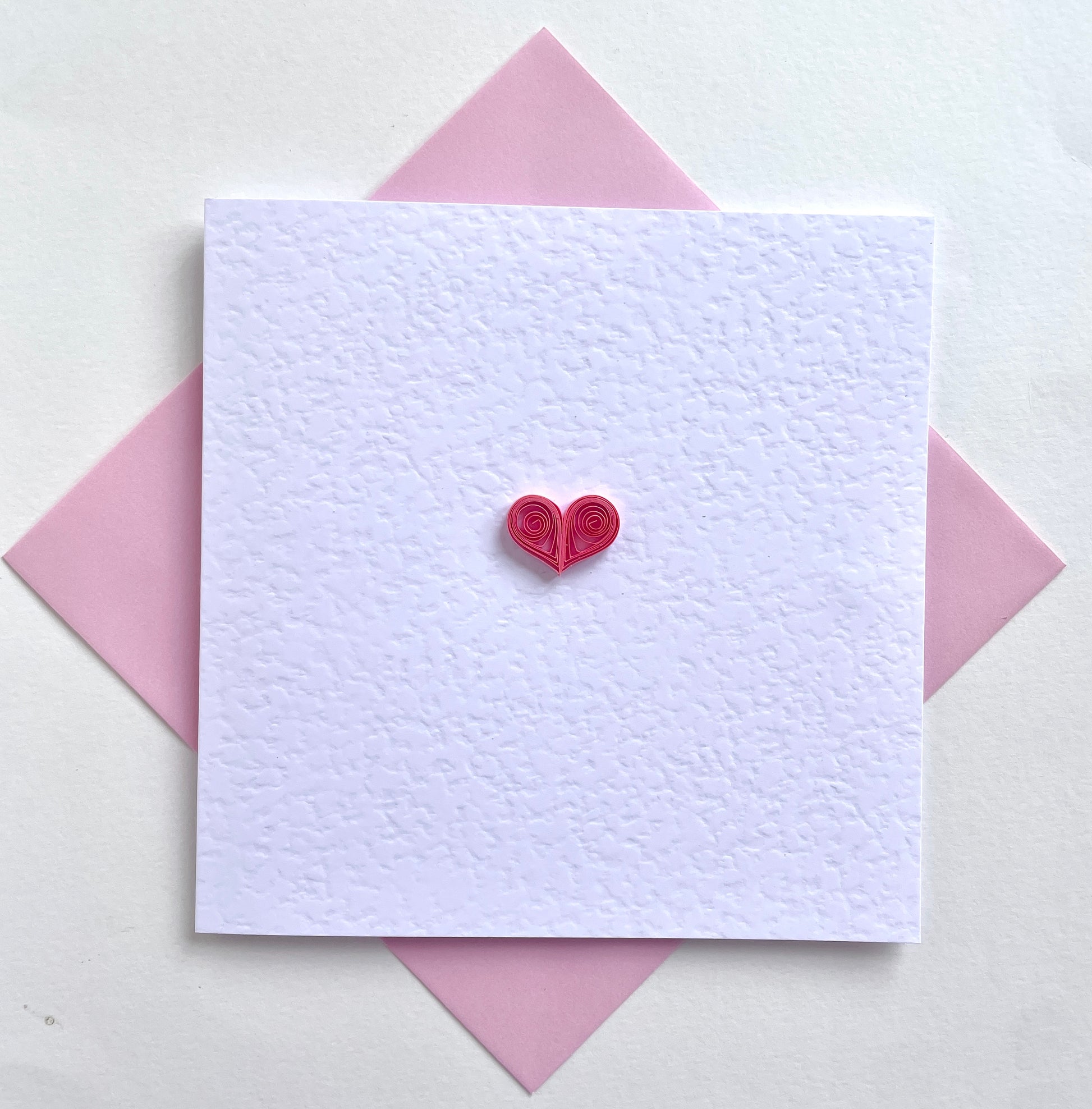 Pretty pink heart on white hammer card with pink envelope. Love & friendship greetings card for her