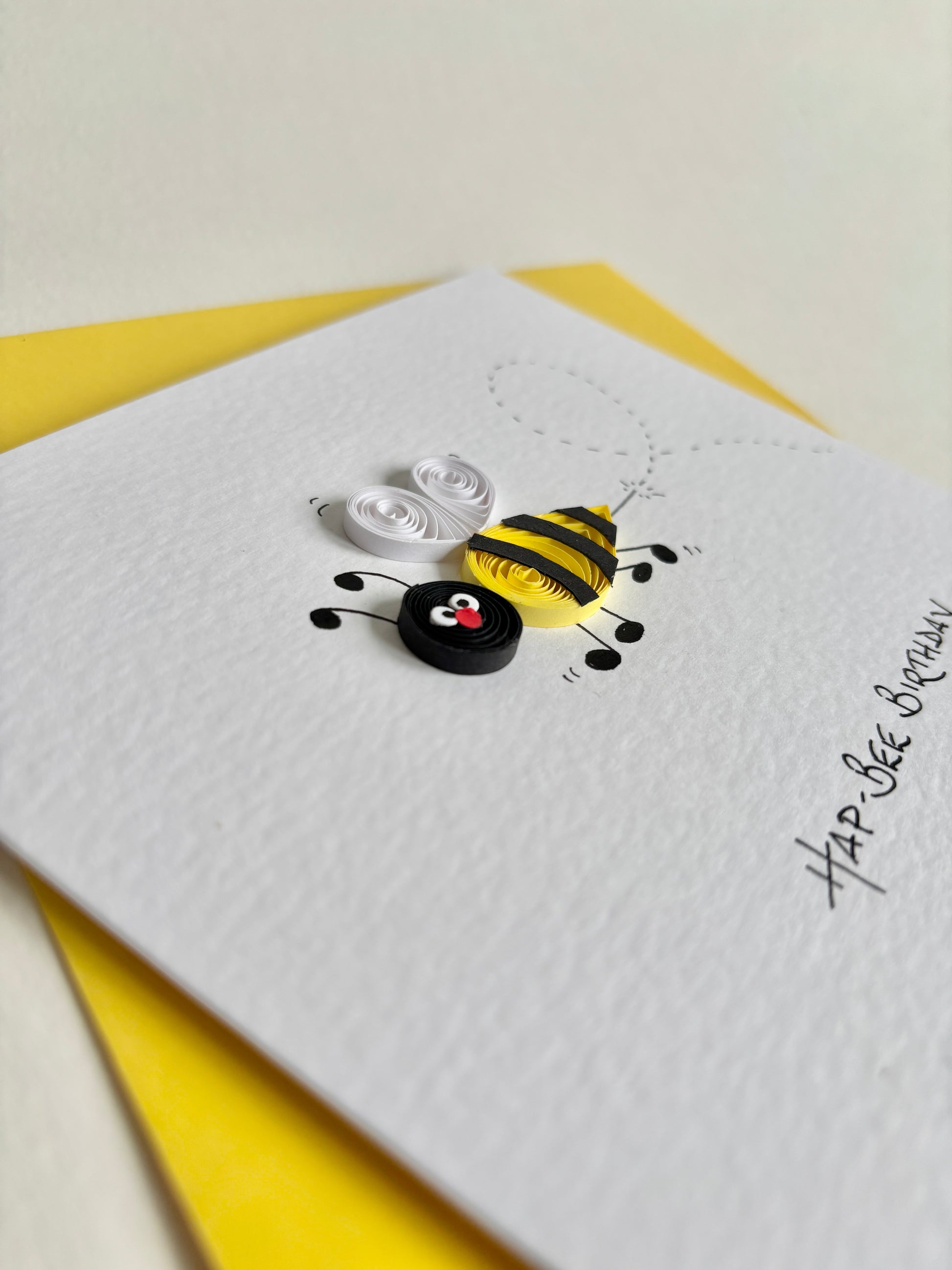 Bumble bee greetings card with a bee design and 'Happy Birthday' text on a yellow envelope.