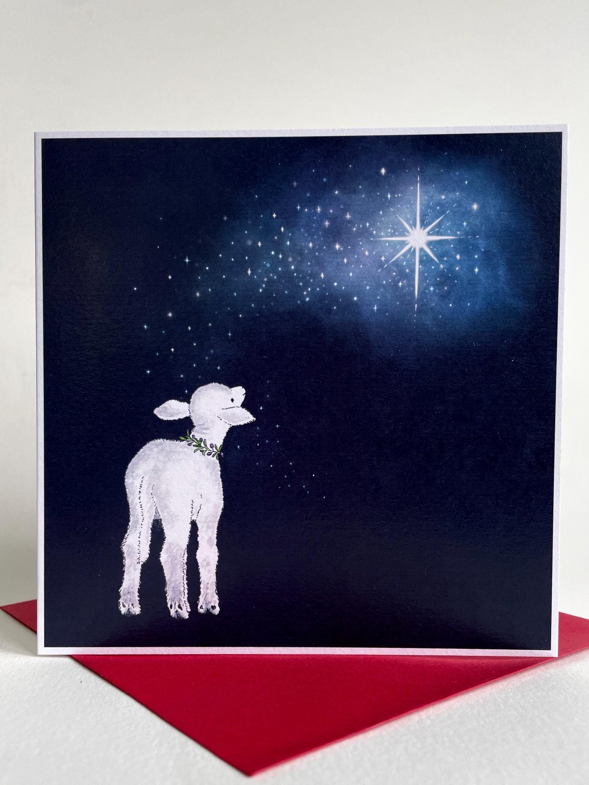 A charming Christmas card design featuring a baby lamb looking up at the Christmas Star - available with glitter