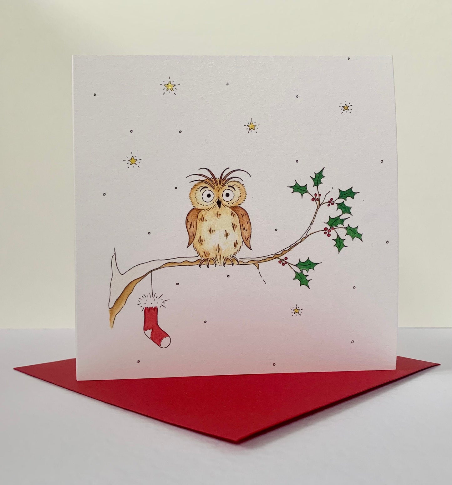 Square 135mm Blue Lobster Cards charity card resting on coordinating christmas red envelope.