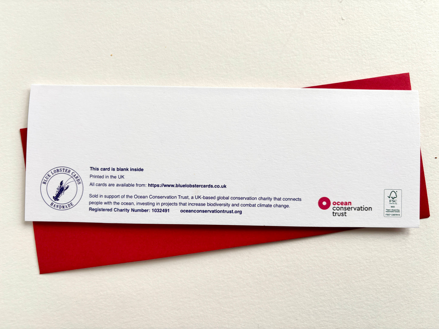 A blank white paper card with printed text and Blue Lobster Cards details. The card includes the FSC certified logo and the Ocean Conservation Trust logo.