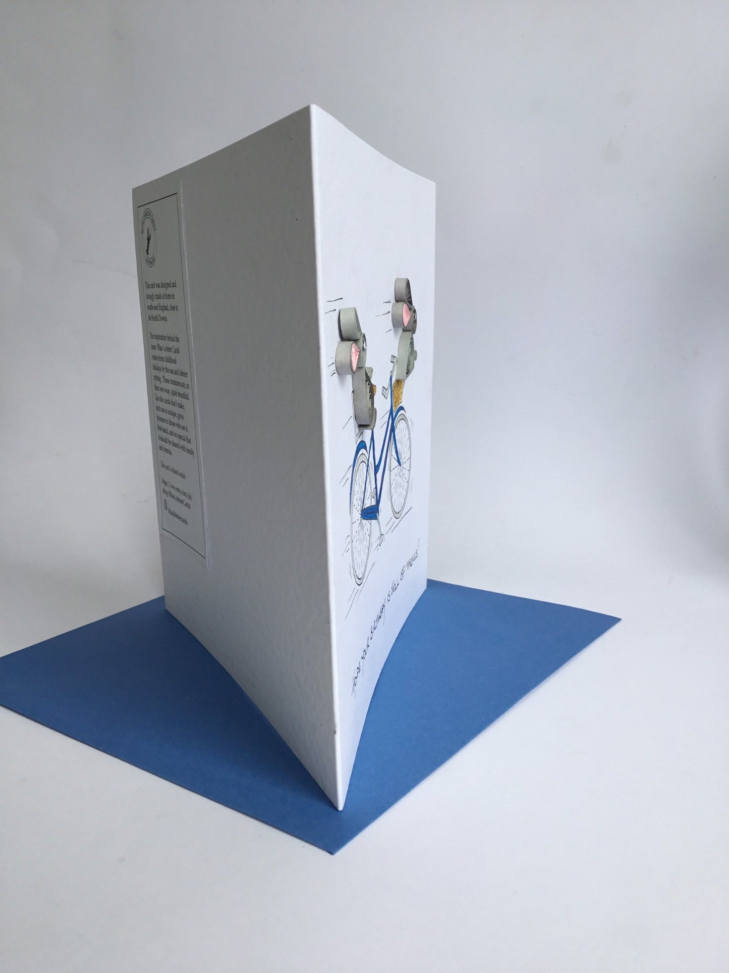 Side view shows relief of paper quilling for hand painted bicycle bunny card from Blue Lobster cards. Made in UK