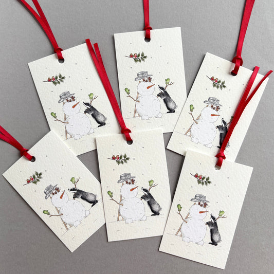 6 traditional Christmas gift tags with red ribbons, printed with my own winter watercolour illustration of a badger, mice and Christmas robins building a Snowman in the snow. 