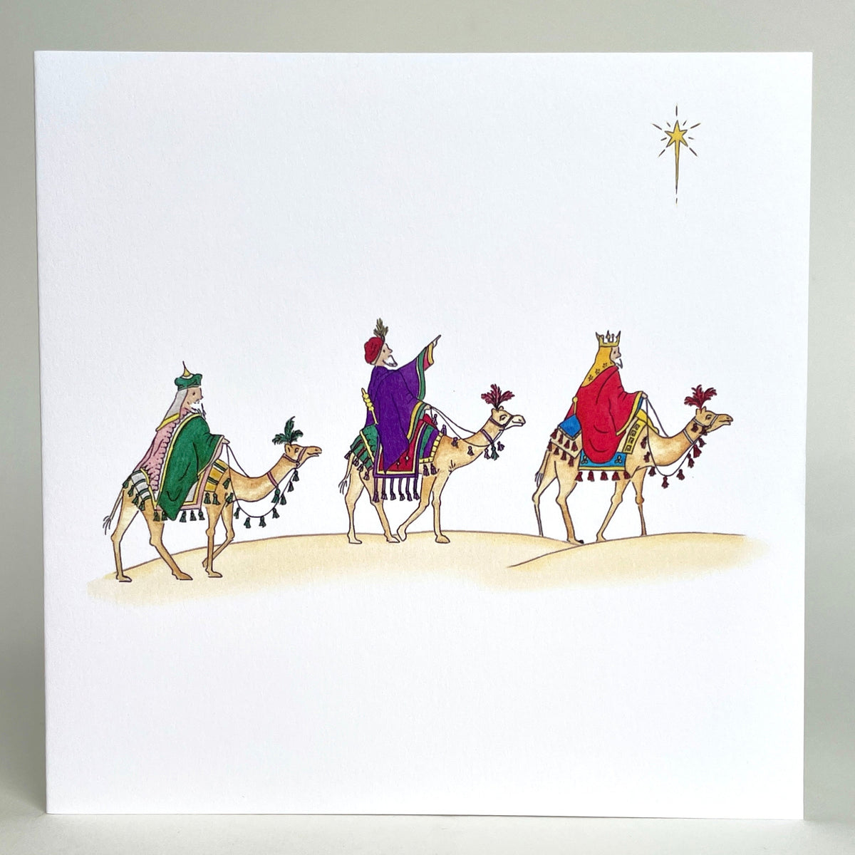 Fine quality charity Christmas card featuring my own watercolour Illustration of three kings on desert camels following the star