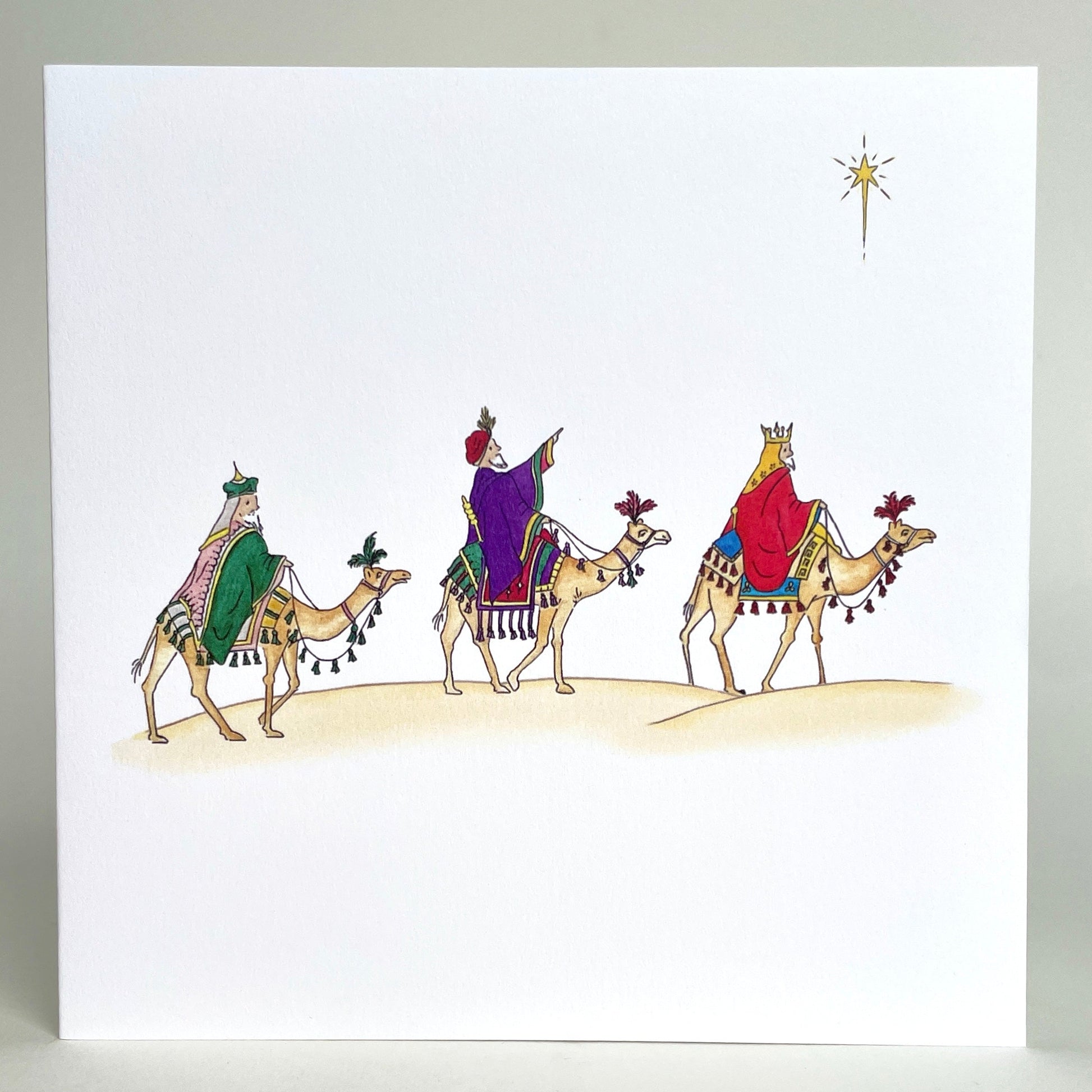 Fine quality charity Christmas card featuring my own watercolour Illustration of three kings on desert camels following the star