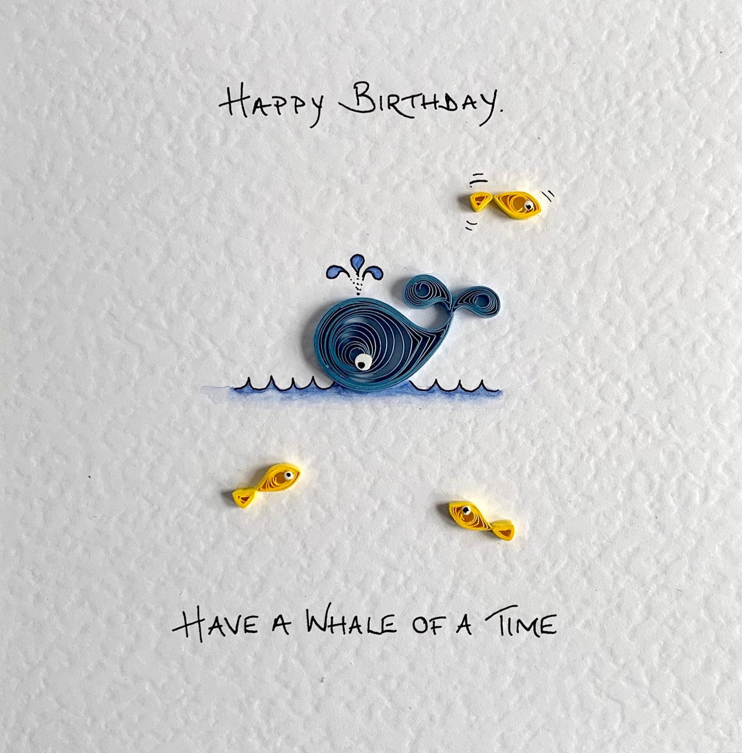 Close-up of quilled paper detail on handmade whale birthday card